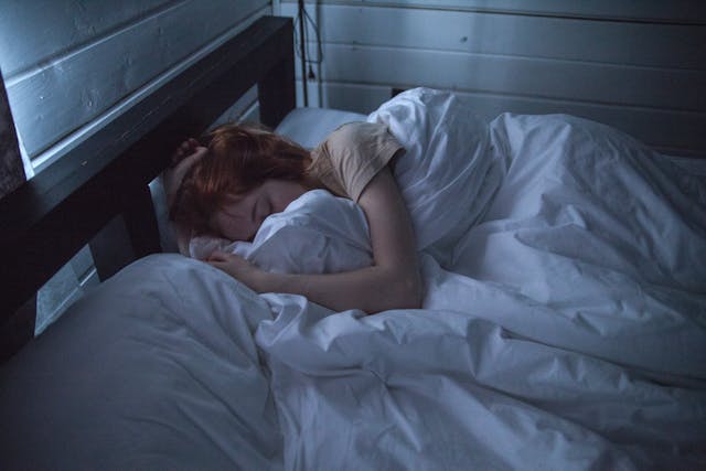 woman laying in a white bed